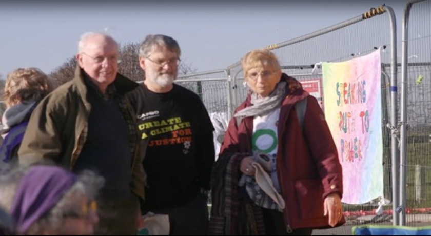 Derek Estill and protesters banner