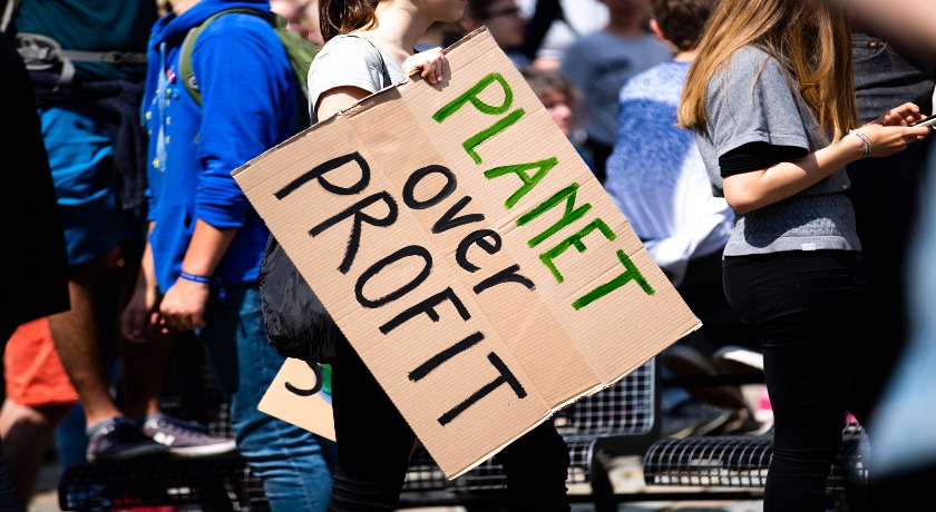 Planet over profit sign credit Markus Spiske on Unsplash