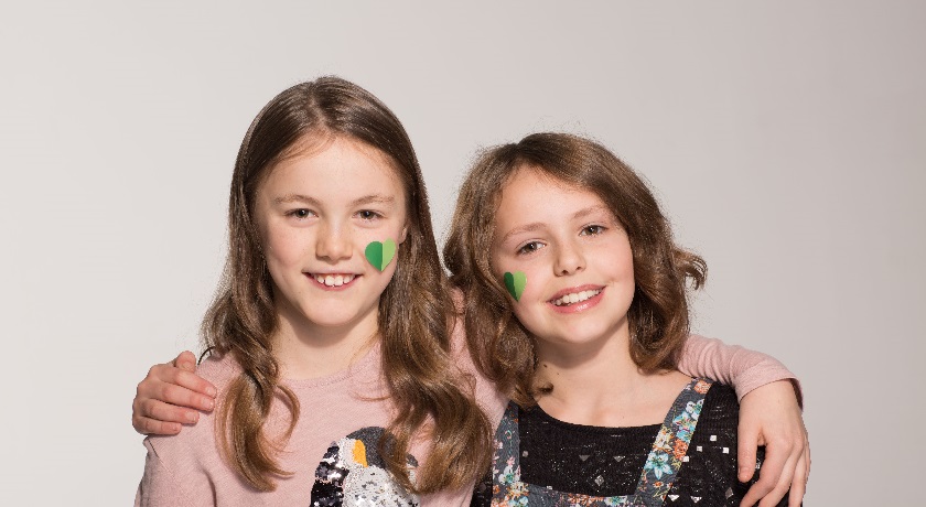 Two girls green hearts credit The Climate Coalition